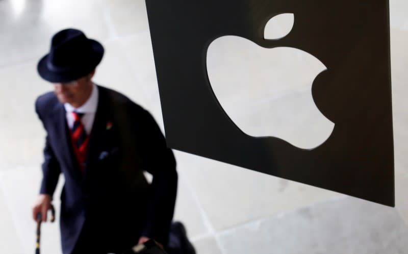 A customer enters the new Apple store, which is the world's largest, on its opening day at Covent Garden in London August 7, 2010. REUTERS/Suzanne Plunkett/File Photo