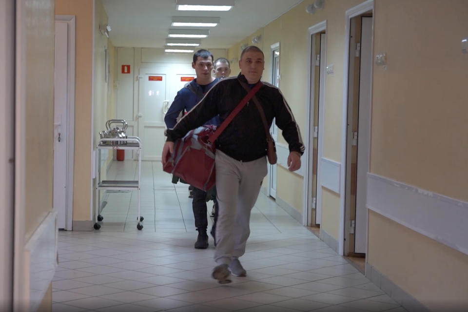 In this photo made from footage provided by the Russian Defense Ministry on Wednesday, July 15, 2020, a group of volunteers participating in a trial of a coronavirus vaccine leave their rooms at the Budenko Main Military Hospital outside Moscow, Russia. Russia is boasting that it’s about to be the first country to approve a COVID-19 vaccine, but scientists worldwide are sounding the alarm that the headlong rush could backfire. (Russian Defense Ministry Press Service via AP)