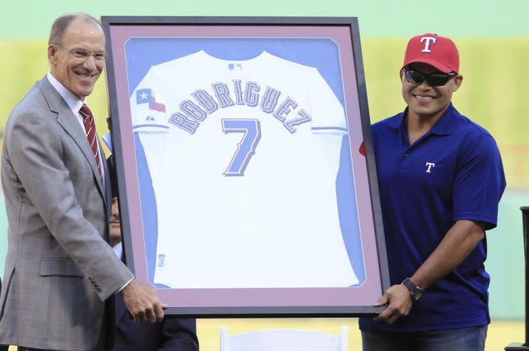 Tom Grieve presented Ivan Rodriguez with his No. 7 jersey following his retirement. (AP)