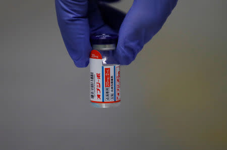 A staff member of the National Cancer Center Hospital shows the immune system-boosting cancer drug Opdivo during a photo opportunity at the hospital in Tokyo, Japan December 26, 2018. Picture taken December 26, 2018. REUTERS/Kim Kyung-Hoon