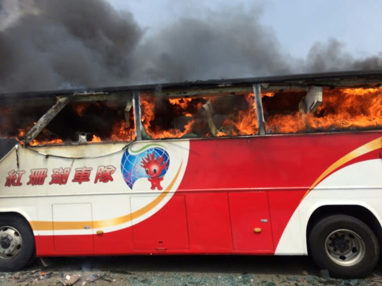 A tour bus carrying Chinese tourists burns after it crashed along an expressway on its way to the airport in Taoyuan, Taiwan on July 19, 2016