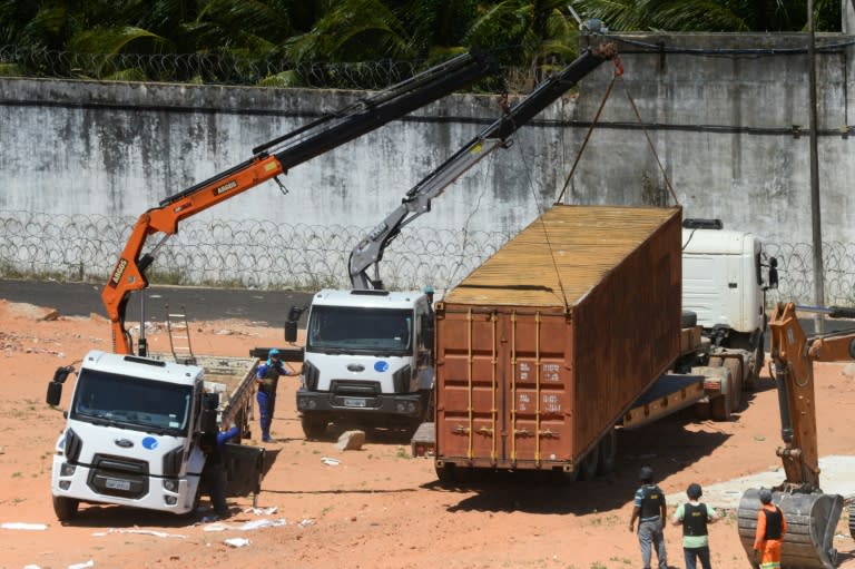 Police build a barrier using containers to separate rival factions after violent clashes between gangs in the Alcacuz Penitentiary Center near Natal in Rio Grande do Norte, Brazil, on January 21, 2017