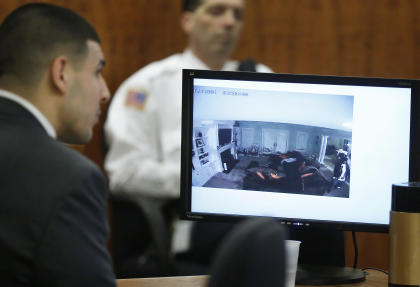 Aaron Hernandez watches as a still frame from video is displayed on a monitor. (AP)