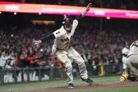 San Francisco Giants' Mike Yastrzemski celebrates after scoring against the San Diego Padres during the ninth inning of a baseball game in San Francisco, Monday, June 19, 2023. (AP Photo/Jeff Chiu)