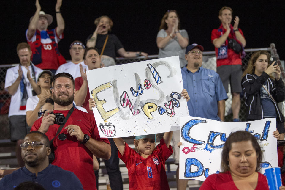 A young United States fan holds up a sign advocating for equal pay for women's soccer players after the United States defeated Japan in a SheBelieves Cup women's soccer match, Wednesday, March 11, 2020 at Toyota Stadium in Frisco, Texas. (AP Photo/Jeffrey McWhorter)