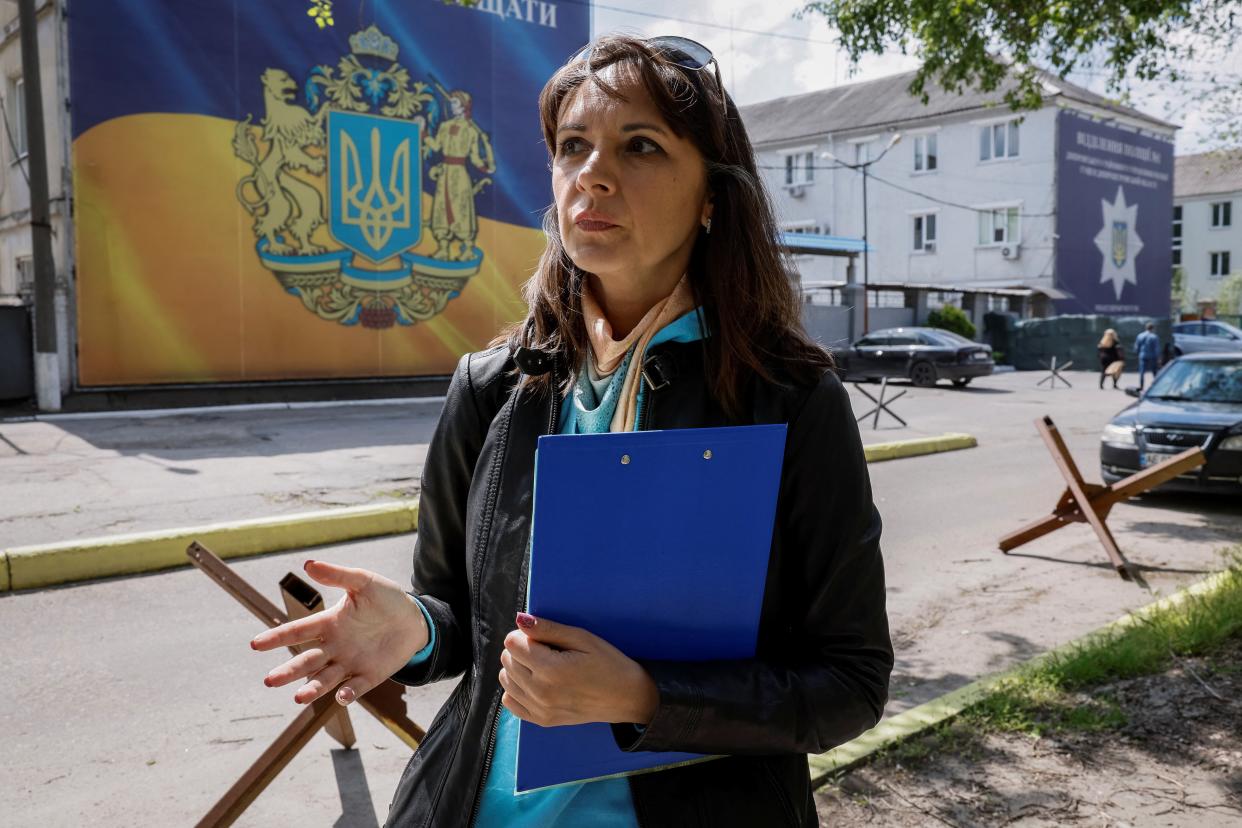 Yulia Seheda, a lawyer for domestic violence victims, appears in front of a local police office in Dnipro (REUTERS)