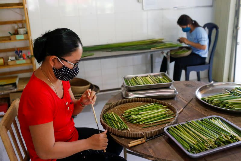 Workers make straws from grass at the 3T workshop in Long An province