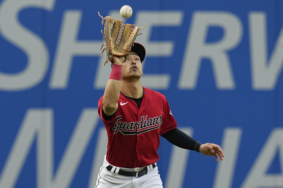 Cleveland Guardians left fielder Steven Kwan catches a fly ball hit for an out by Chicago White Sox's Yasmani Grandal in the fifth inning of a baseball game Monday, May 22, 2023, in Cleveland. (AP Photo/Sue Ogrocki)