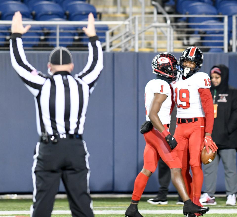 Glenville's Demarion Witten (19) celebrates his first-quarter TD catch with teammate Jermaine Foster vs. Wyoming in the OHSAA Division IV state final at Tom Benson Hall of Fame Stadium. Saturday, Dec. 3, 2022.