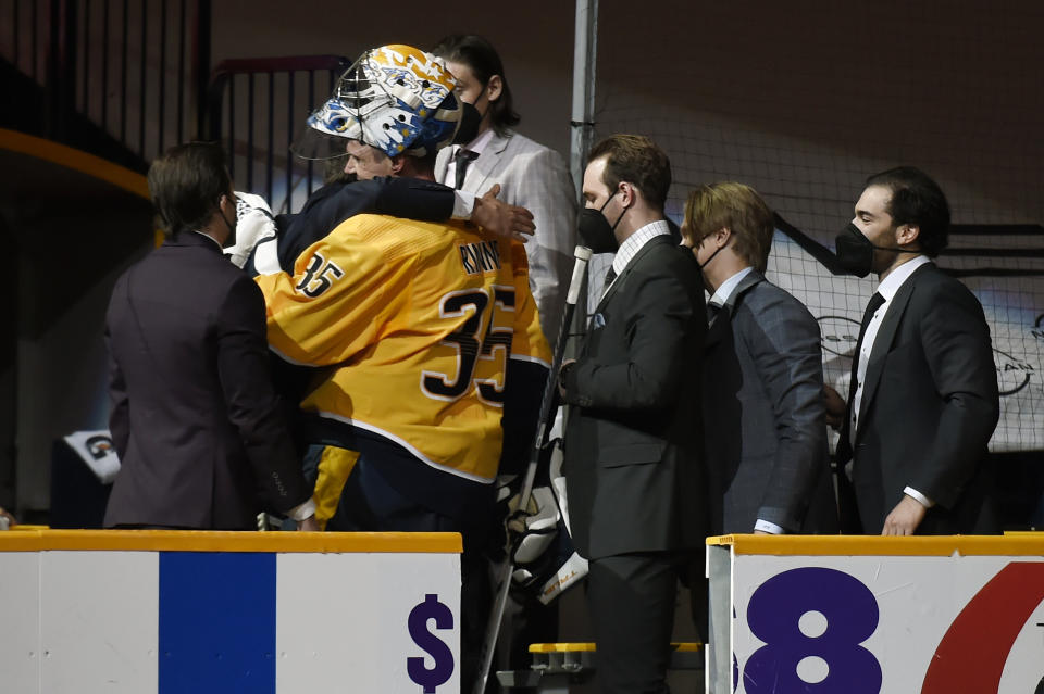 Nashville Predators goaltender Pekka Rinne (35) receives a hug after leaving the ice after the Predators defeated the Carolina Hurricanes in an NHL hockey game Monday, May 10, 2021, in Nashville, Tenn.(AP Photo/Mark Zaleski)