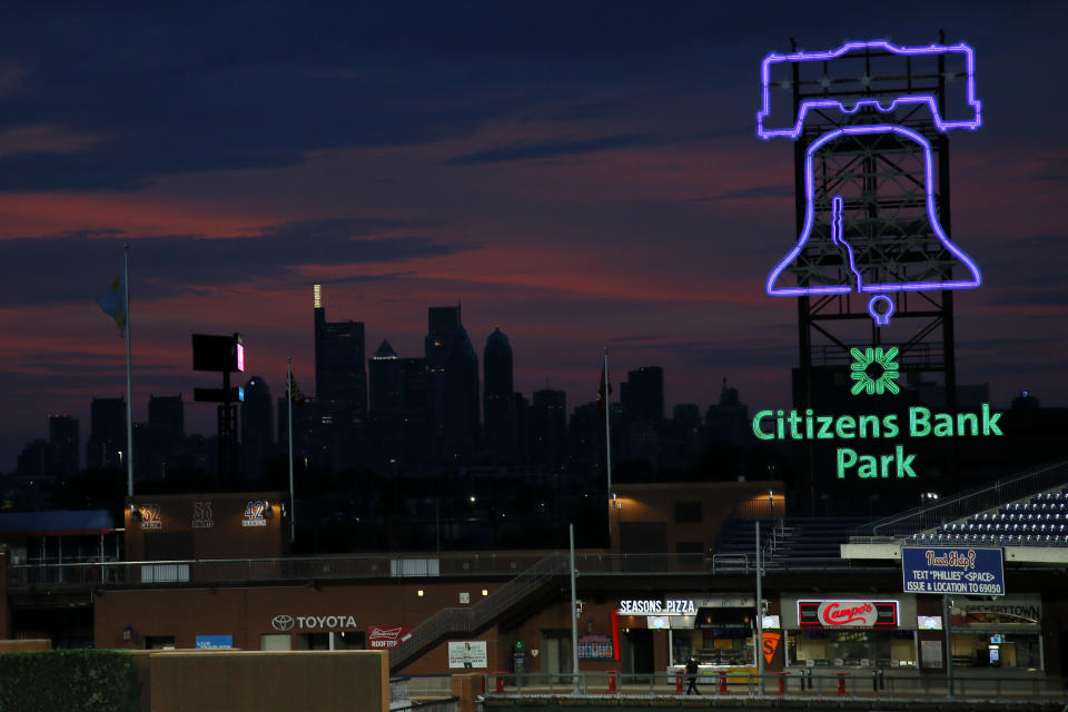 FILE - In this Aug. 6, 2020 file photo, the Philadelphia skyline is viewed during sunset at Citizens Bank Park in Philadelphia. Bird Safe Philly announced on Thursday, March 11, 2021, that Philadelphia is joining the national Lights Out initiative, a voluntary program in which as many external and internal lights in buildings are turned off or dimmed at night during the spring and fall bird migration seasons. Millions of birds annually migrate through Philadelphia during spring and fall and many are killed when they fly into buildings, confused by the bright artificial lights and glass. (AP Photo/Matt Slocum, File)
