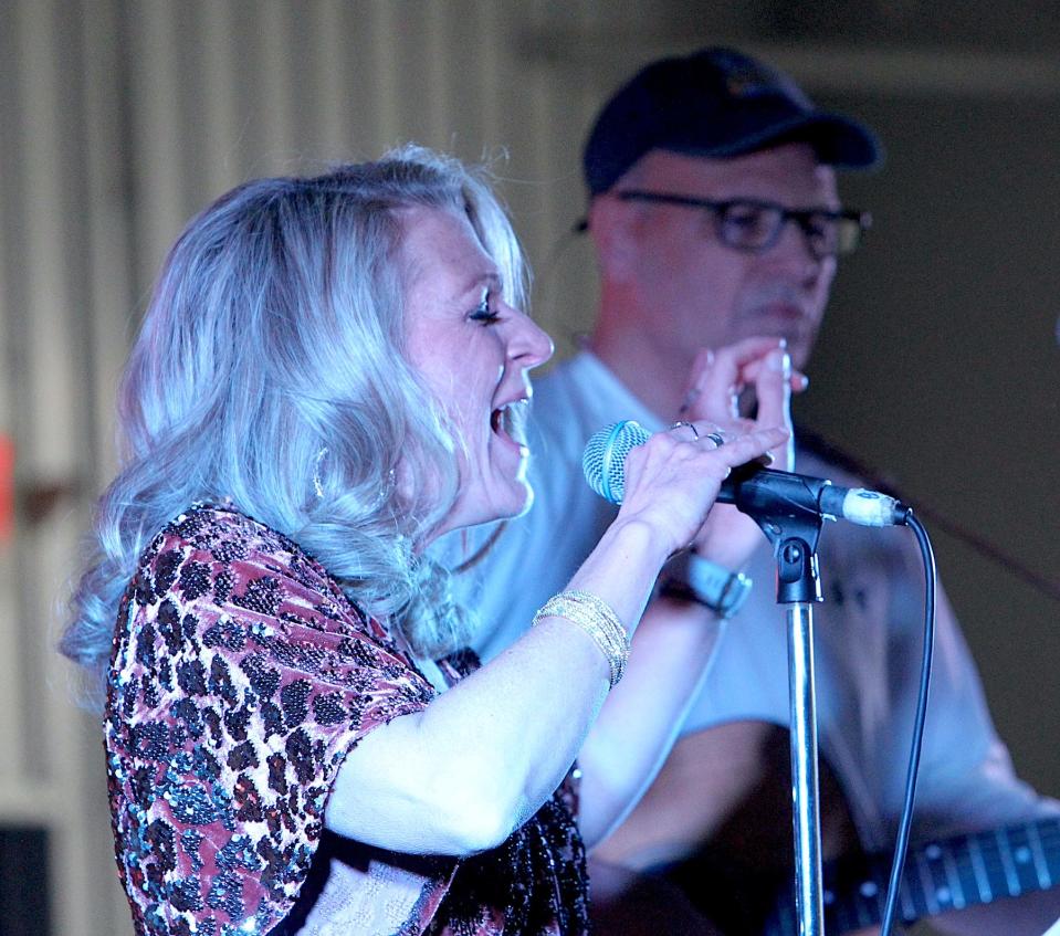 JoAnna Cobb performs as half of the duo Jo and Kev Saturday, April 6, 2024, during the Eclipse Over Lawrence County celebration. The other half, Kevin Hudson is in the background.