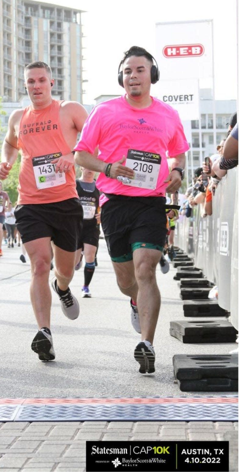 David Ramos, in the pink shirt, ran in the Cap10K for the first time last year.