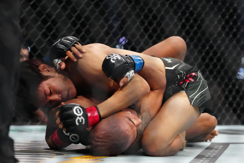 Jul 8, 2023; Las Vegas, Nevada, USA; Tatsuro Taira (red gloves) fights Edgar Chairez (blue gloves) during UFC 290 at T-Mobile Arena. Mandatory Credit: Stephen R. Sylvanie-USA TODAY Sports