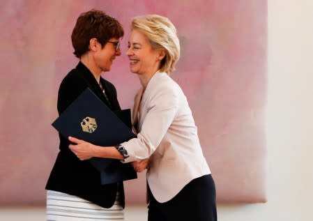 Outgoing German defence Minister Ursula von der Leyen and incoming German defence Minister Annegret Kramp-Karrenbauer shake hands after receiving certificates from Berlin mayor Michael Mueller, during a ceremony at Bellevue Palace