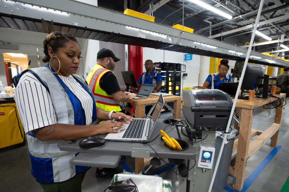 Amazon employees work in the stow and picking area at the Amazon Robotic Sorting Fulfillment Center in Canton Miss., Thursday, Aug. 11, 2022. The million, square-foot-facility is the first Amazon robotics sort center in the state.