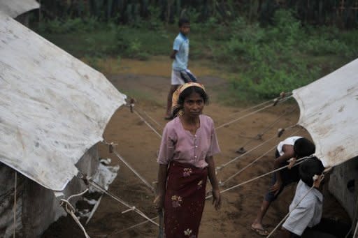 A Myanmar Muslim Rohingya stands in a temporary relief camp for people displaced by days of sectarian violence on the outskirts of Sittwe in June 2012. Speaking a Bengali dialect similar to one in southeast Bangladesh, the Rohingyas are Muslims seen as illegal immigrants by the Buddhist-majority Myanmar government and many Burmese