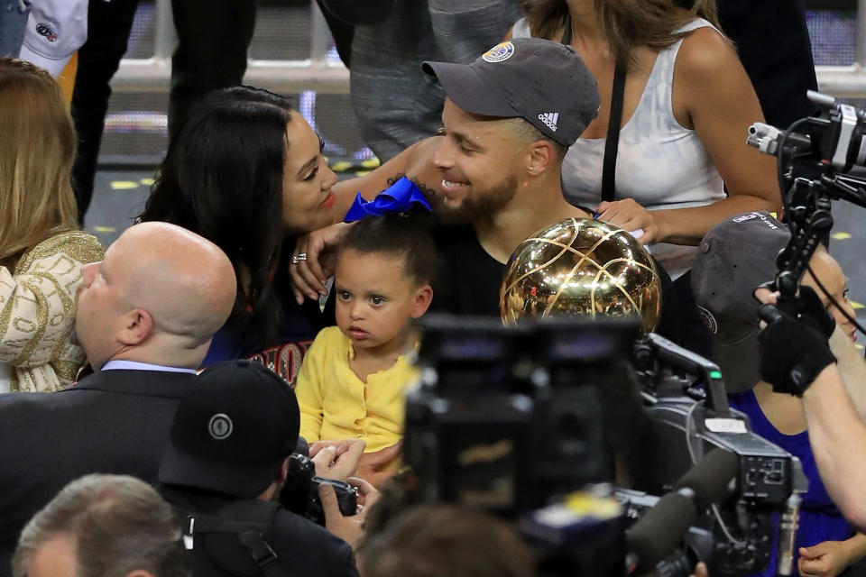 Stephen Curry of the Golden State Warriors celebrates with his wife Ayesha after defeating the Cleveland Cavaliers 129-120 in Game 5 to win the 2017 NBA Finals at ORACLE Arena on June 12, 2017 in Oakland, California. (Photo by Ronald Martinez/Getty Images)