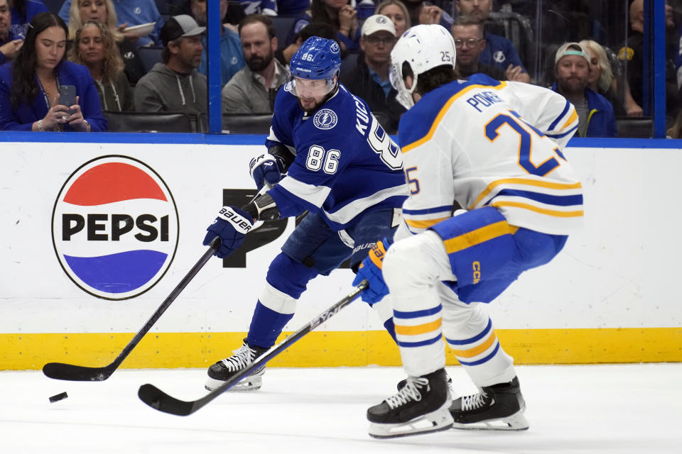 Tampa Bay Lightning right wing Nikita Kucherov (86) flips the puck past Buffalo Sabres defenseman Owen Power (25) during the second period of an NHL hockey game Monday, April 15, 2024, in Tampa, Fla. (AP Photo/Chris O'Meara)