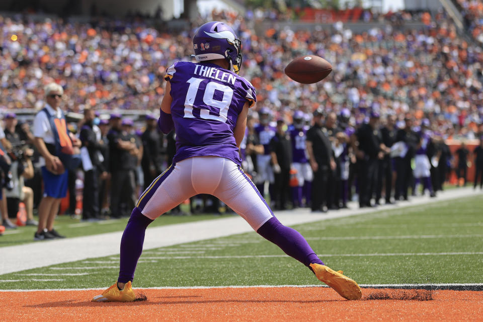 Minnesota Vikings wide receiver Adam Thielen (19) makes a catch for a touchdown against the Cincinnati Bengals in the first half of an NFL football game, Sunday, Sept. 12, 2021, in Cincinnati. (AP Photo/Aaron Doster)