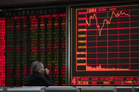 An investor monitors share prices at a brokerage house in Beijing, Wednesday, March 27, 2019. Shares were mixed in Asia early Wednesday after U.S. stocks finished broadly higher on Wall Street, erasing modest losses from a day earlier. (AP Photo/Andy Wong)