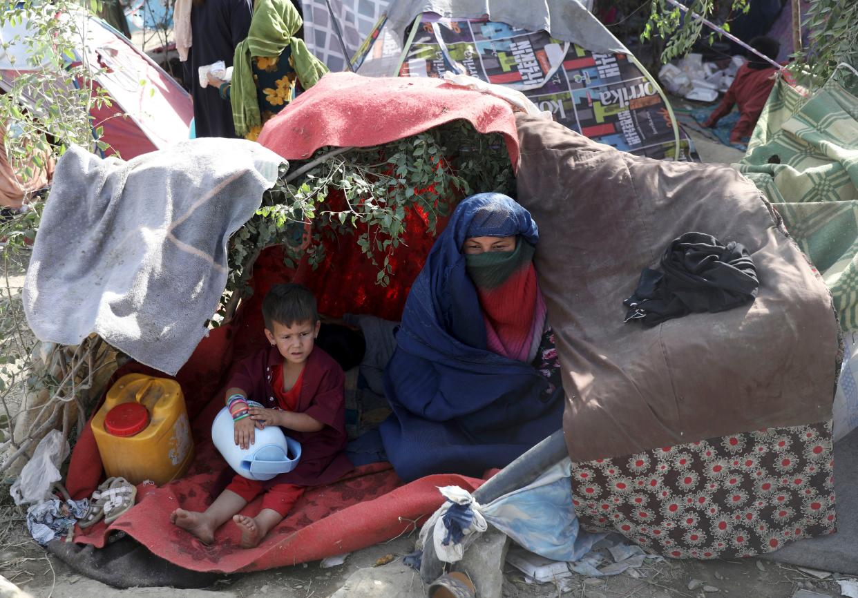 Internally displaced Afghans from northern provinces, who fled their home due to fighting between the Taliban and Afghan security personnel, take refuge in a public park in Kabul, Afghanistan, Friday, Aug. 13, 2021. The Taliban have completed their sweep of the country's south on Friday, as they took four more provincial capitals in a lightning offensive that is gradually encircling Kabul, just weeks before the U.S. is set to officially end its two-decade war.