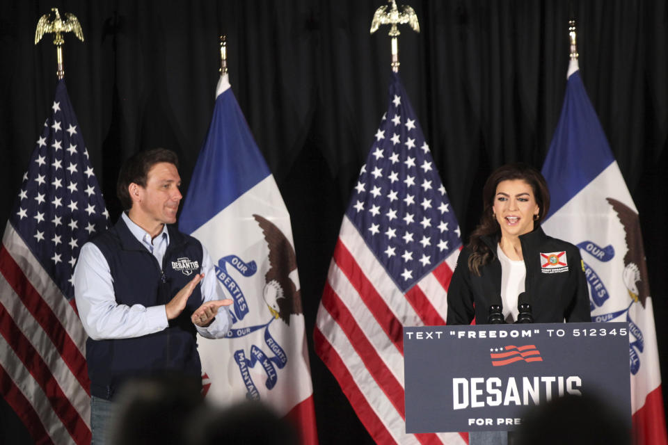 Florida Gov. Ron DeSantis applauds as his wife, Casey DeSantis, speaks to voters at a rally in Council Bluffs, Iowa, Wednesday. Several hundred people filled half of an event center to listen to DeSantis speak in his first trip to Iowa since announcing his presidential campaign. (AP Photo/Josh Funk)