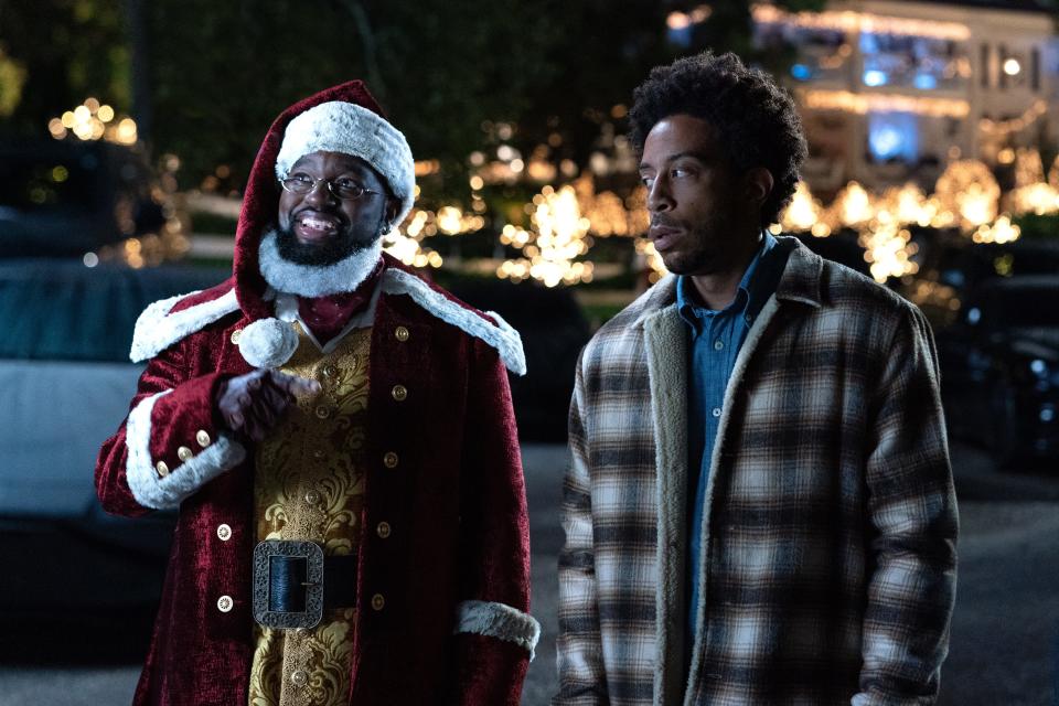 Chris "Ludacris" Bridges (right) stars as a holiday-hating social worker who meets a mysterious man in a red suit named Nick (Lil Rel Howery) and thinks he might be delusional in the Disney+ comedy "Dashing Through the Snow."