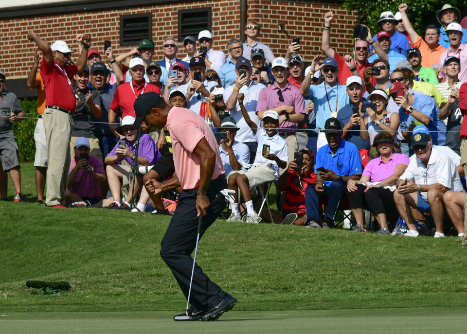 RETRANSMISSION TO CORRECT FROM A BIRDIE TO AN EAGLE - Tiger Woods reacts as he makes a eagle putt on the 18th green during the first round of the Tour Championship golf tournament Thursday, Sept. 20, 2018, in Atlanta. (AP Photo/John Amis)