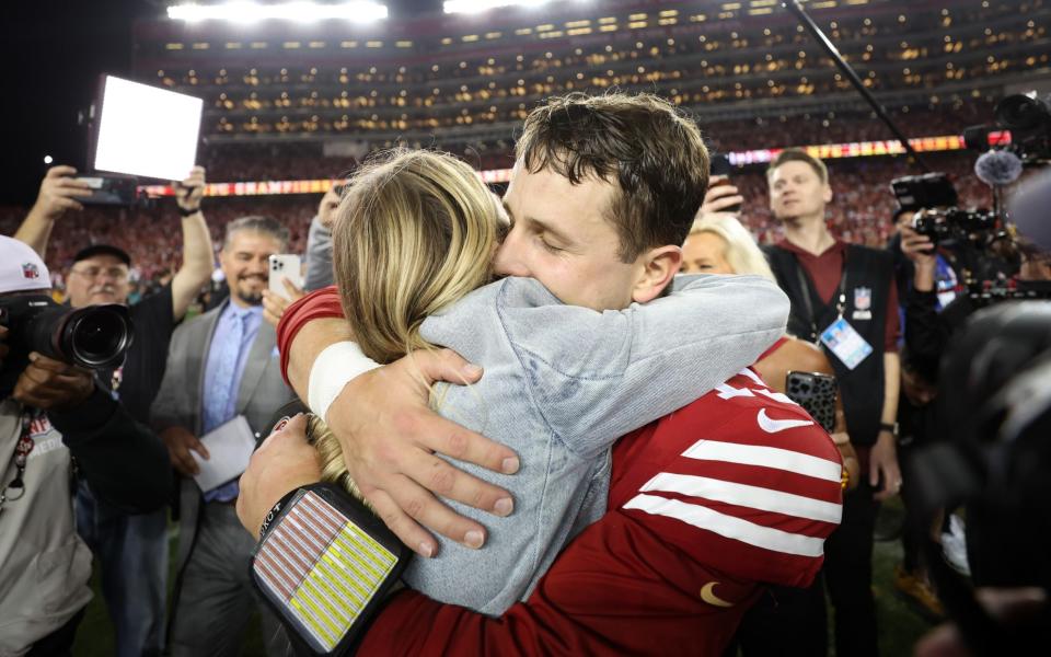 Brock Purdy #13 of the San Francisco 49ers hugs girlfriend Jenna Brandt