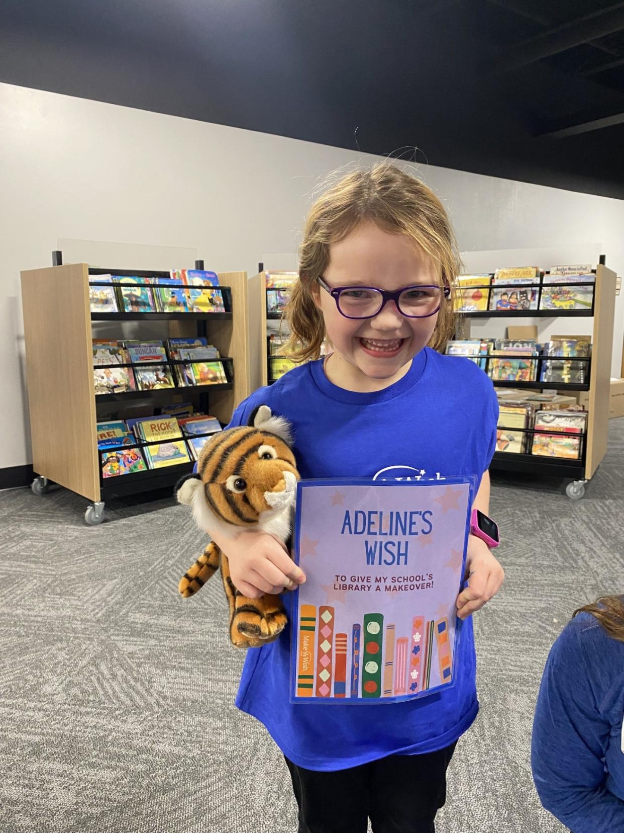 Adeline Ory celebrates the reveal of her Make-a-Wish: a makeover of the Earlham Community School District library.