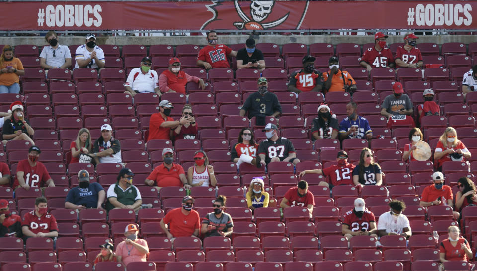 FILE - Socially distanced fans are shown during the second half of an NFL football game between the Minnesota Vikings and the Tampa Bay Buccaneers in Tampa, ion this Sunday, Dec. 13, 2020, file photo. Hall of Famer Warren Sapp wishes the Tampa Bay Buccaneers could pack the stands for the first Super Bowl played in a host team's home stadium. (AP Photo/Jason Behnken, FIle)