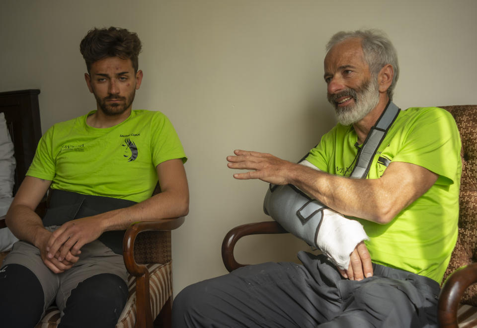 The team leader, Tarcisio Bellò, 57, talks to the Associated Press with team member Luca Morellato in Islamabad, Pakistan, Thursday, June 20, 2019. A renowned Italian mountaineer, who narrowly survived along-with six other members of an expedition on a mountain, burst into tears Thursday when he recalled how helplessly he saw one of his Pakistani colleagues being swept away by an avalanche that struck them at an altitude of around 5,300 meters (17,390 feet) earlier this week. (AP Photo/B.K. Bangash)