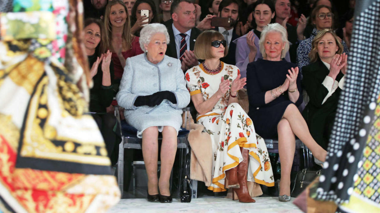 (FILES) In this file photo taken on February 20, 2018 Britain's Queen Elizabeth II, accompanied by Chief Executive of the British Fashion Council (BFC), Caroline Rush (L), British-American journalist and editor, Anna Wintour (2R) and royal dressmaker Angela Kelly, views British designer Richard Quinn's runway show before presenting him with the inaugural Queen Elizabeth II Award for British Design, during her visit to London Fashion Week's BFC Show Space in central London. - Queen Elizabeth II, the longest-serving monarch in British history and an icon instantly recognisable to billions of people around the world, has died aged 96, Buckingham Palace said on September 8, 2022.  Her eldest son, Charles, 73, succeeds as king immediately, according to centuries of protocol, beginning a new, less certain chapter for the royal family after the queen's record-breaking 70-year reign. (Photo by Yui Mok / POOL / AFP)