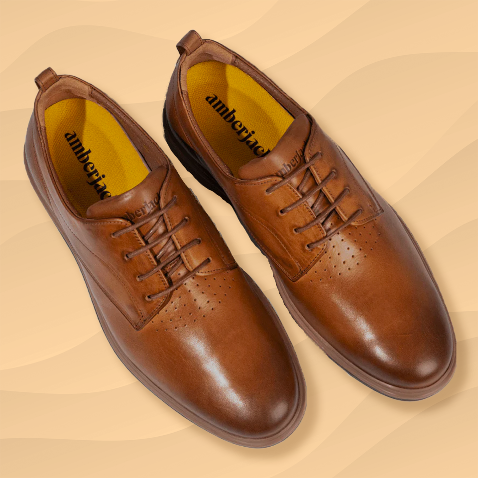 the amberjack original derby shoes in honey brown tan against a wavy orange background