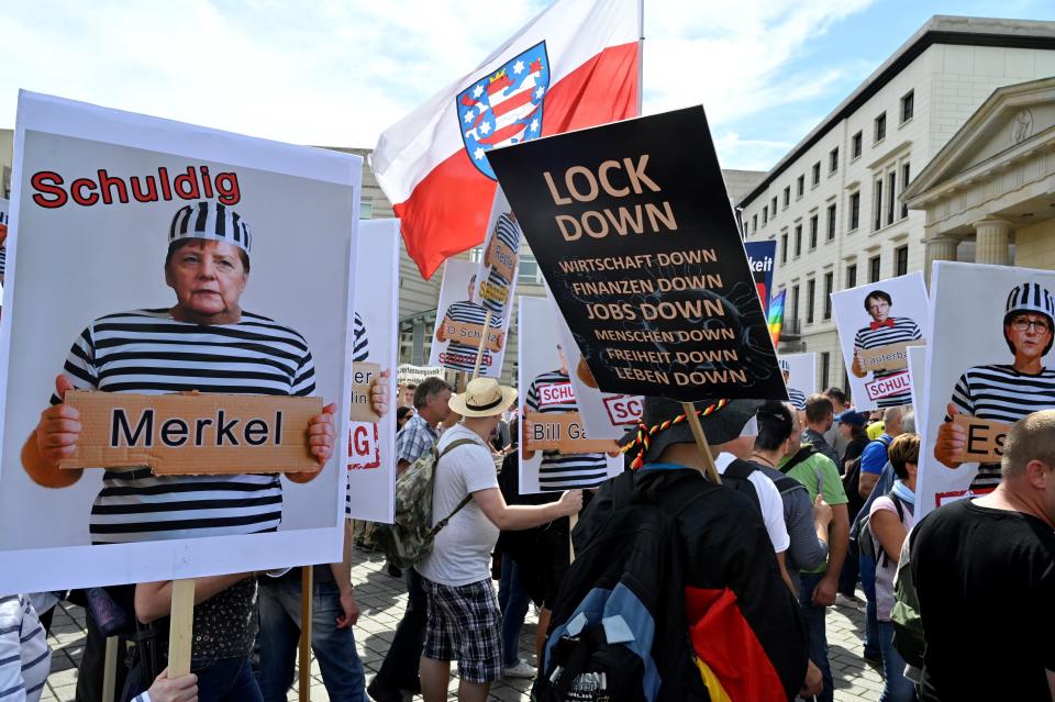 A placard featuring German chancellor Angela Merkel as prisonner is seen during a demonstration called by far-right and COVID-19 deniers to protest against restrictions related to the new coronavirus pandemic, on August 29, 2020 in Berlin. (Photo by John MACDOUGALL / AFP) (Photo by JOHN MACDOUGALL/AFP via Getty Images) / Credit: JOHN MACDOUGALL
