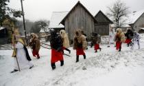 Revellers dressed as devils walk through the village of Valasska Polanka