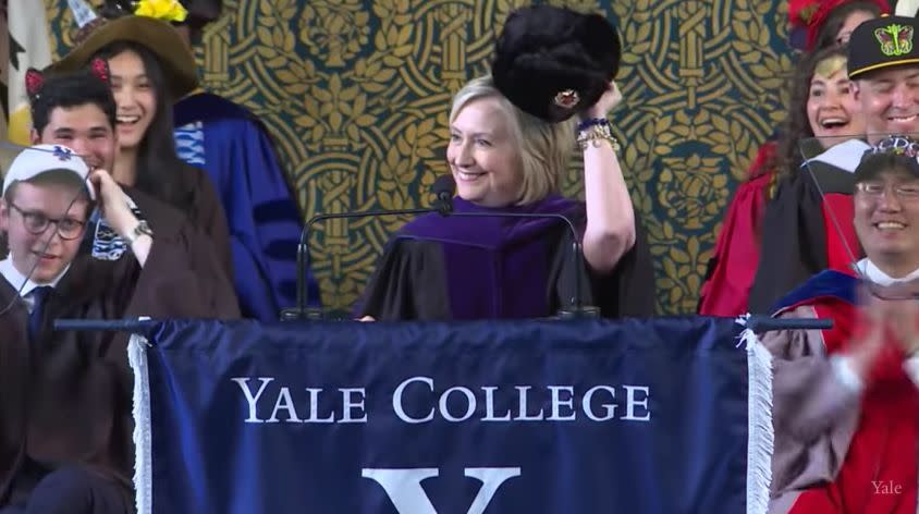 As per Yale tradition, Hillary Clinton brought a hat to commencement. (Photo: YouTube/Yale University)