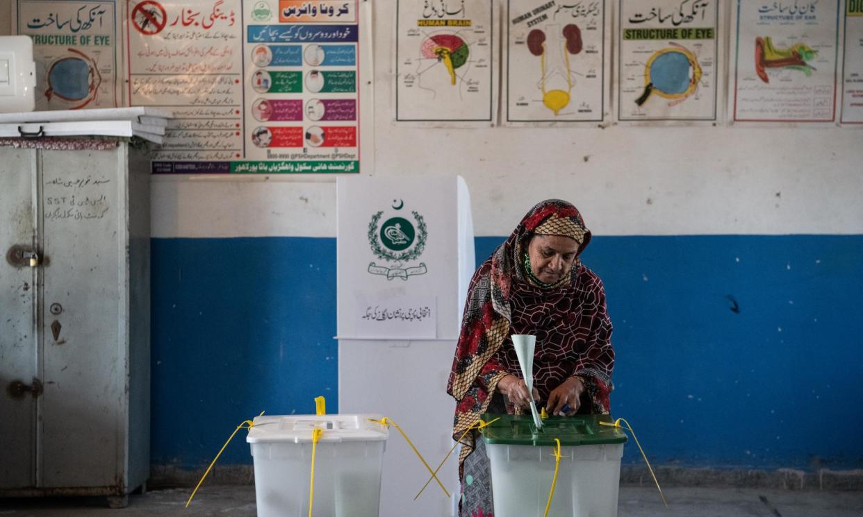 <span>A Pakistani voter casts her ballot during the general election at a polling station on 8 February 2024 in Wahgrian, Pakistan.</span><span>Photograph: Rebecca Conway/Getty Images</span>