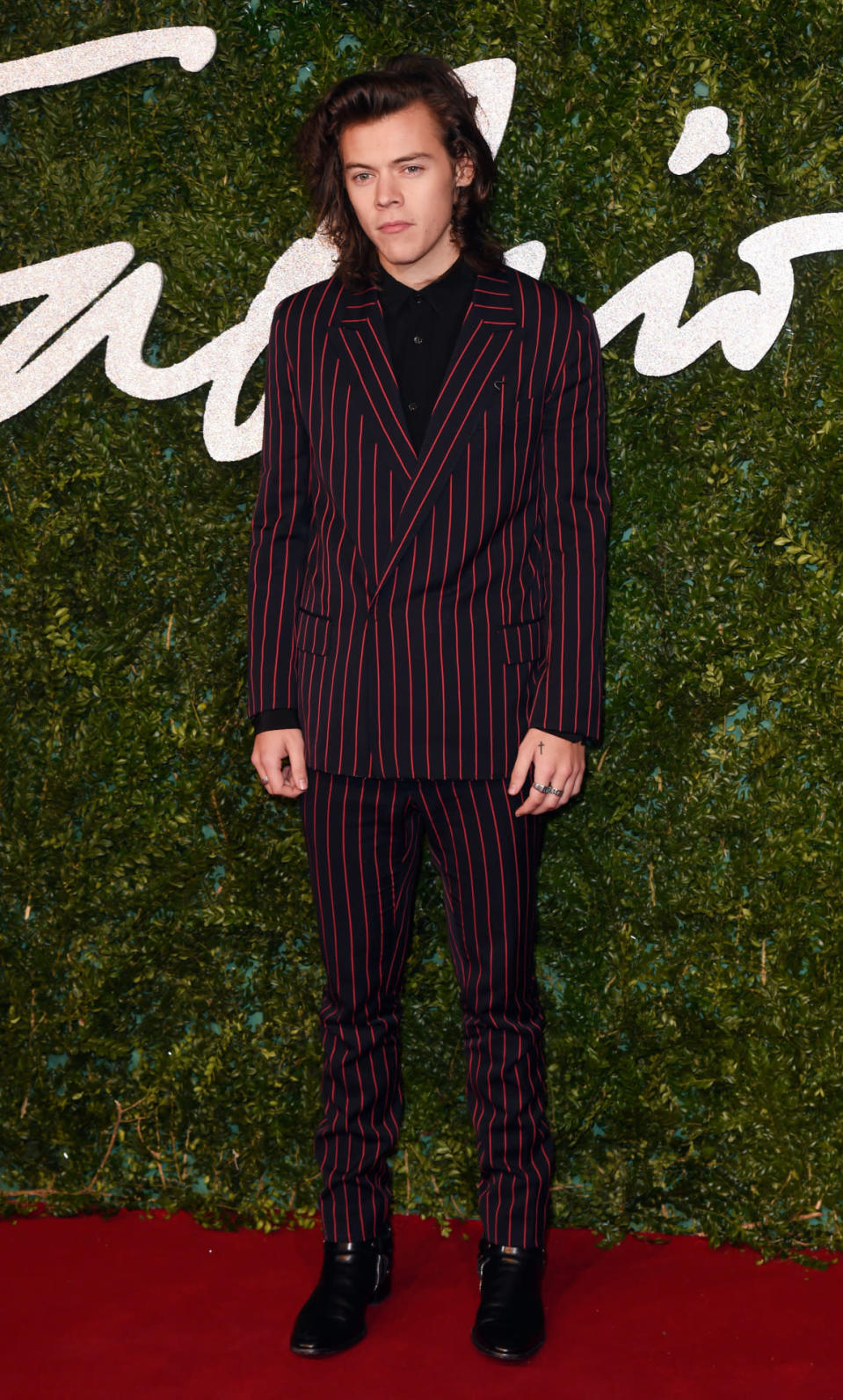 <p>Cutting a dapper figure in a striped Lanvin suit, Styles was easily one of the best dressed stars at the British Fashion Awards 2014. <i>[Photo: Rex]</i></p>