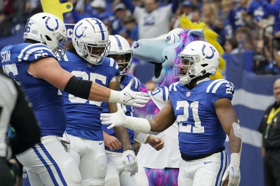Indianapolis Colts running back Zack Moss (21) is congratulated by teammates after a touchdown against the Tennessee Titans during the second half of an NFL football game, Sunday, Oct. 8, 2023, in Indianapolis. | Michael Conroy, Associated Press