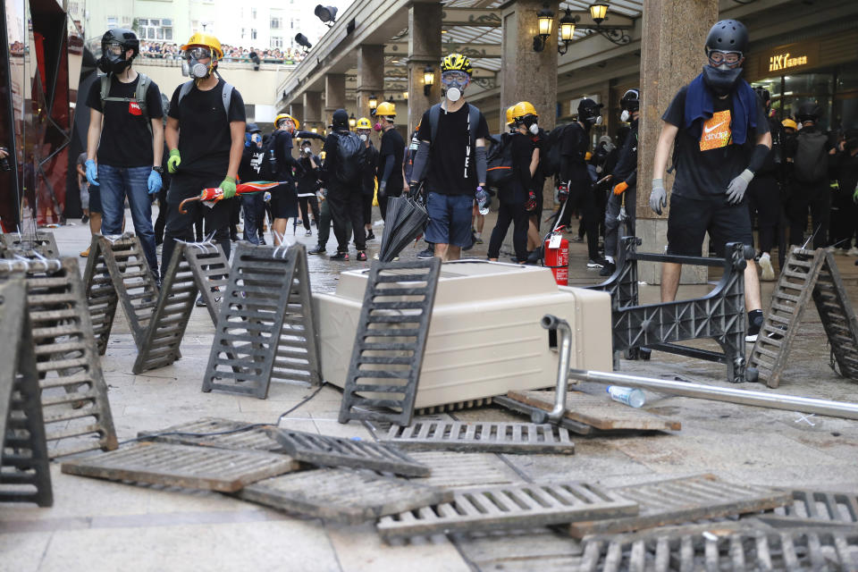 Demonstrators stand behind barricades during a protest in Hong Kong, Saturday, Aug. 24, 2019. Hong Kong protesters skirmished with police on Saturday as chaotic scenes returned to the summer-long protests for the first time in more than a week. (AP Photo/Kin Cheung)