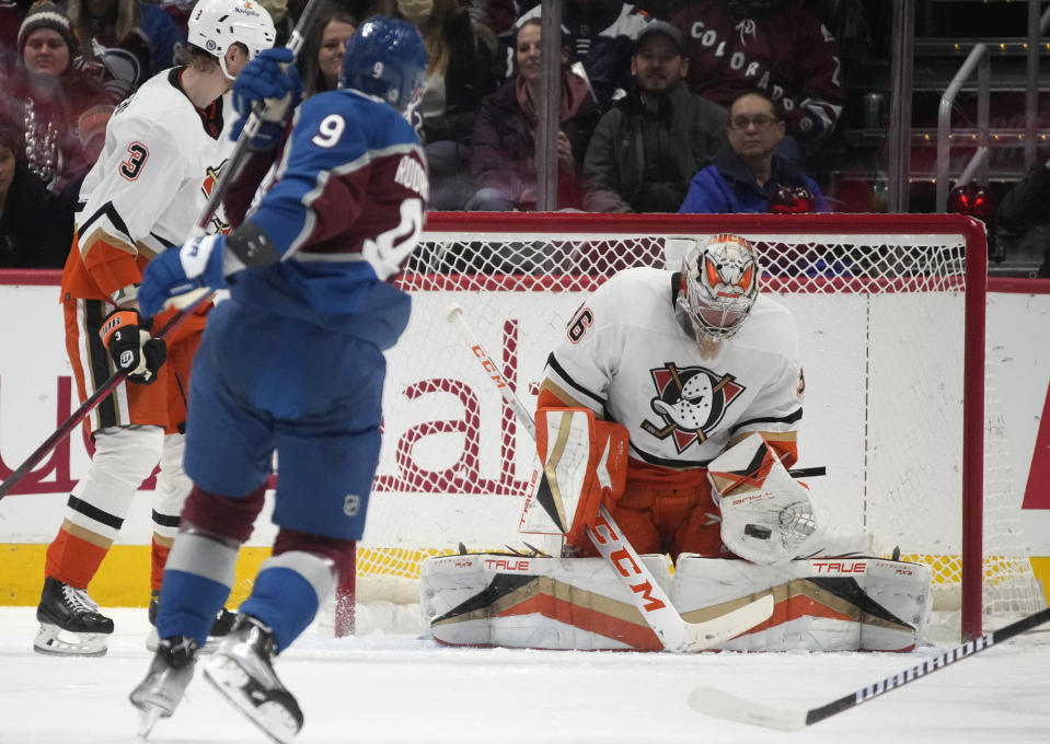 Anaheim Ducks goaltender John Gibson, right, makes a glove-save of a shot by Colorado Avalanche center Evan Rodrigues in the second period of an NHL hockey game Thursday, Jan. 26, 2023, in Denver. (AP Photo/David Zalubowski)