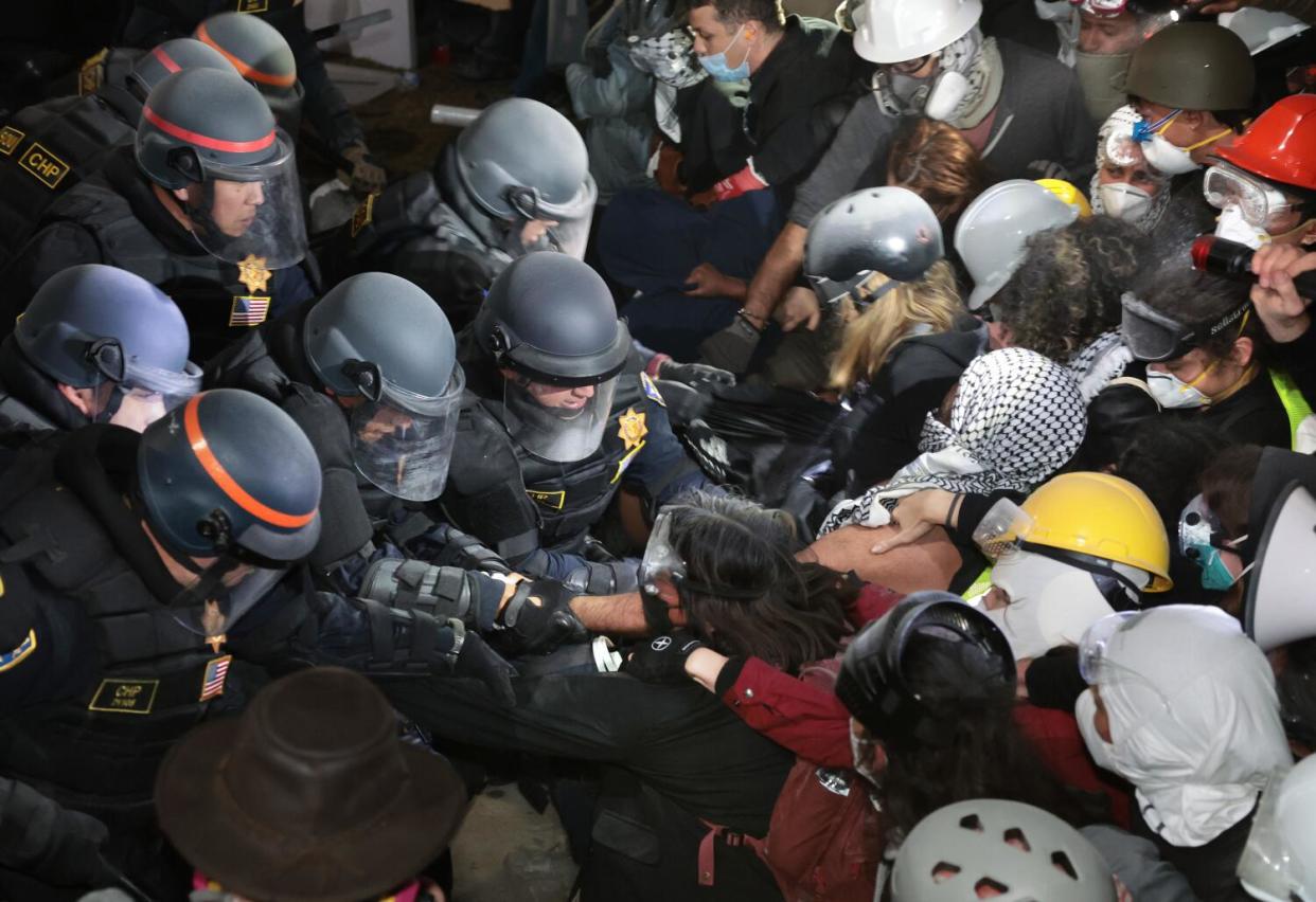 A line of police officers clash with pro-Palestinian protesters at UCLA.