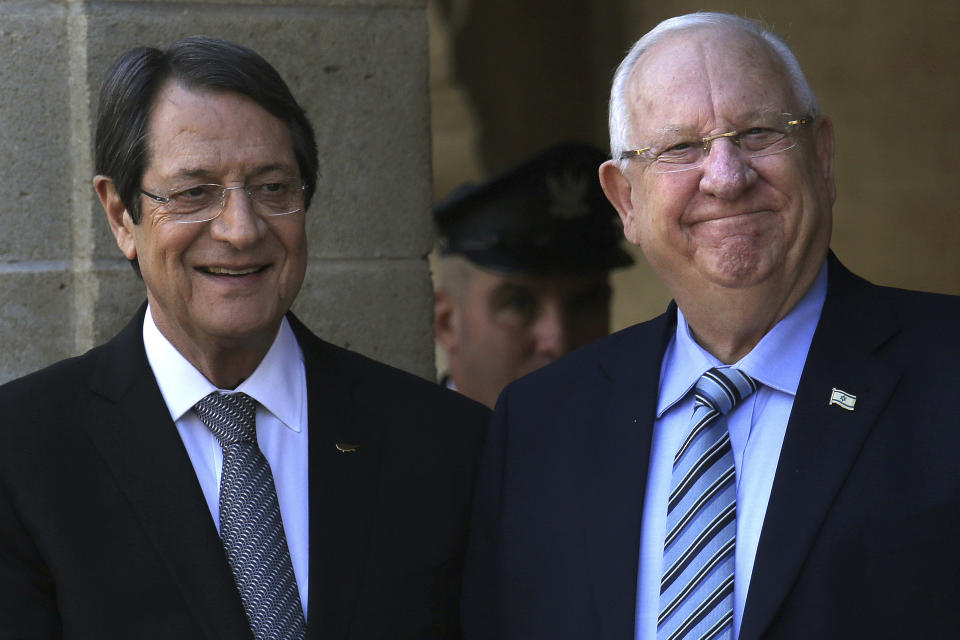 Cyprus' president Nicos Anastasiades, left, and Israel's President Reuven Rivlin smile at the presidential palace in divided capital Nicosia, Cyprus, on Tuesday, Feb. 12, 2019. Rivlin is in Cyprus for a one-day official visit for talks. (AP Photo/Petros Karadjias)