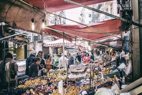 A market in bustling Palermo - Credit: GETTY