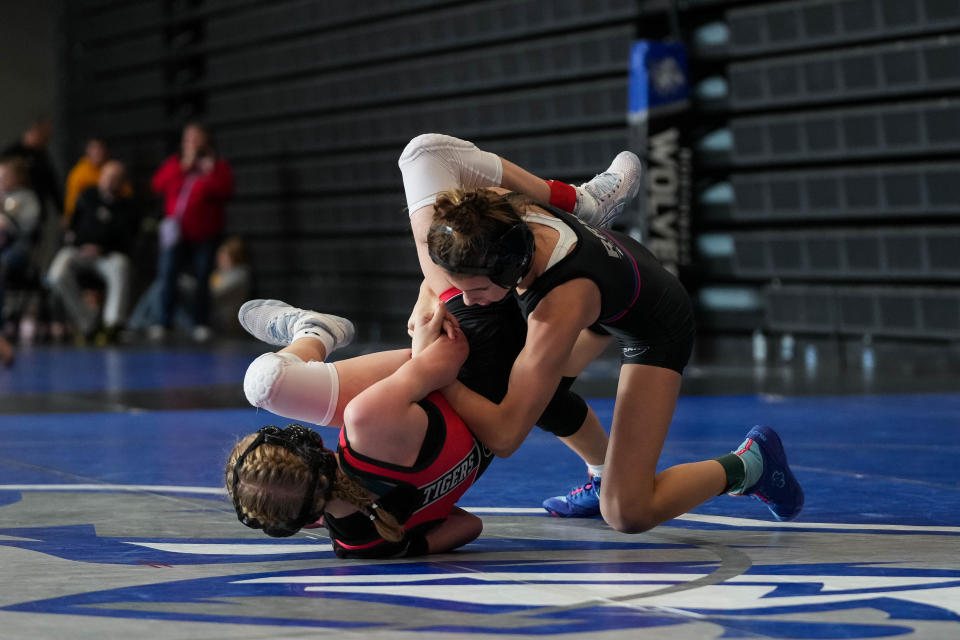 Raccoon River's Katie Biscoglia, right, wrestles Cedar Falls' Natalie Blake during the semifinal round at the Northwest Girls Invite on at Waukee Northwest High School on Saturday, Jan. 14, 2023. Biscoglia won, 14-0, and went on to finish first at 100 pounds.