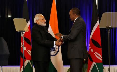 Indian Prime Minister Narendra Modi (L) greets Kenyan President Uhuru Kenyatta after they addressed a joint news conference during his official welcoming ceremony at the State House in Nairobi, Kenya, July 11, 2016. REUTERS/Thomas Mukoya