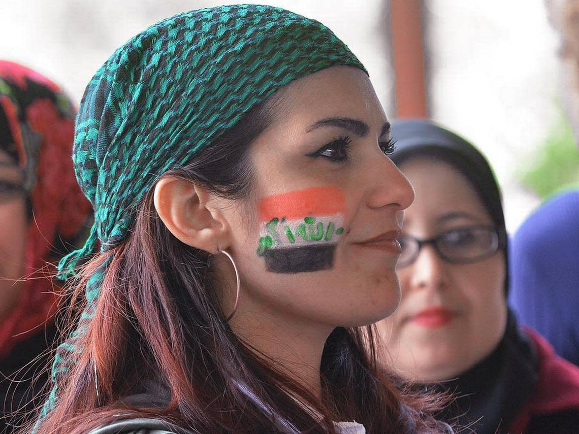 Iraqi Rasha Sherlock celebrates Durham Refugee Day with music, food, games and community education at Durham Central Park Saturday.