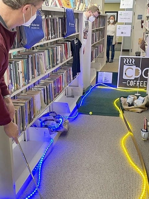 Lights were one of the perks for golfers at this hole sponsored by CDGA Coffee Co. as part of a miniature golf fundraiser at Wood Library. This year's event is March 24-25.